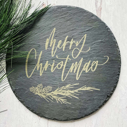 12" round slate tray with merry christmas and a pine sprig engraved in the center